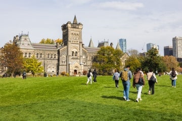 Students walking across the front campus lawn